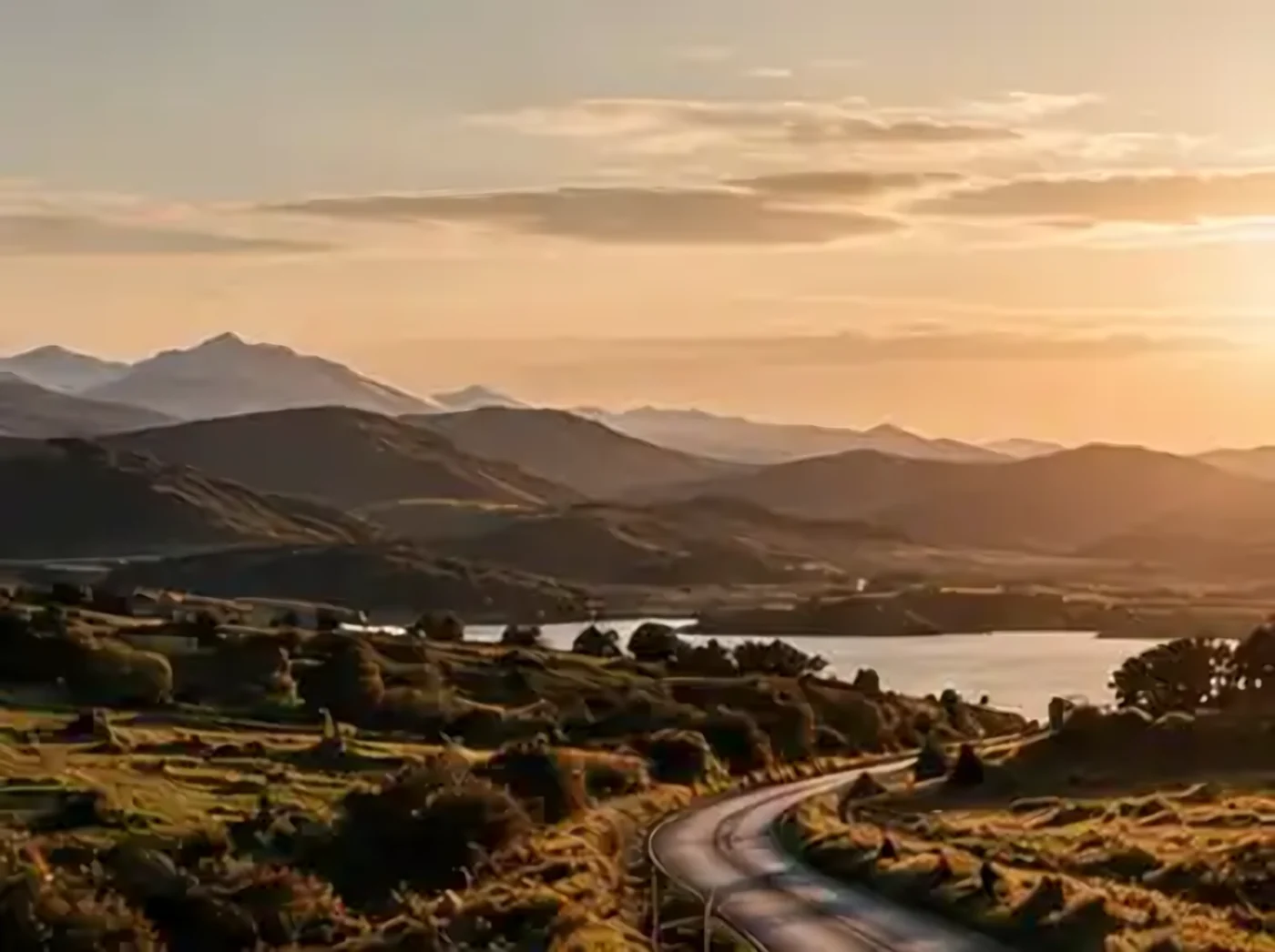 A Highland road and loch at sunset